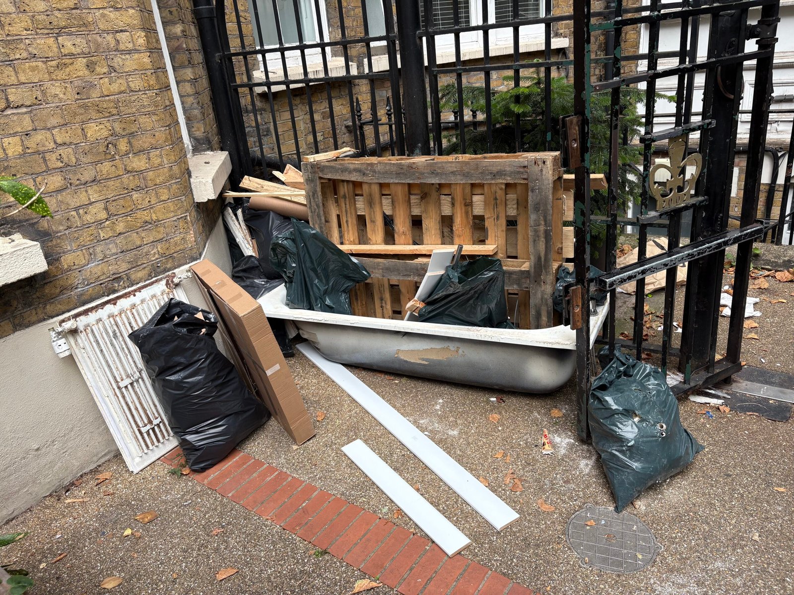Before waste removal in North London – mixed waste piled inside property