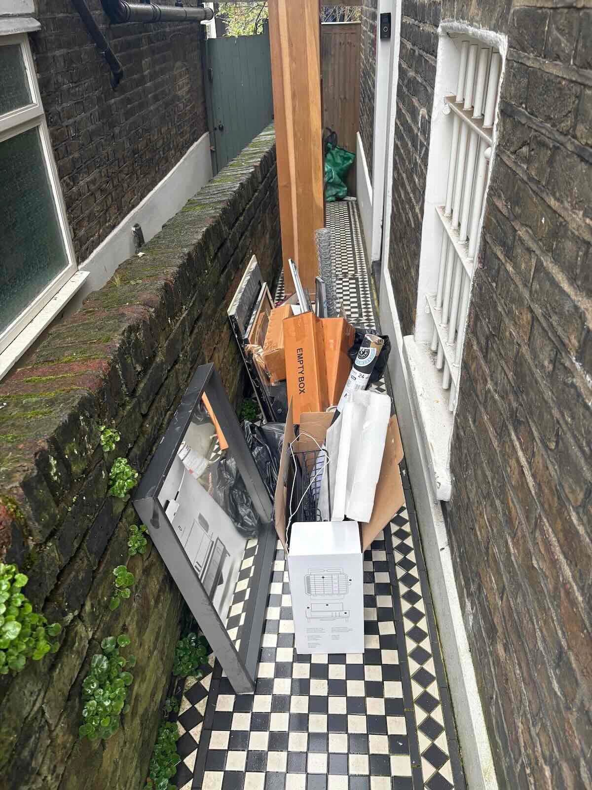 Before side passage clearance N1 – mixed waste and timber blocking access on Southgate Road Islington