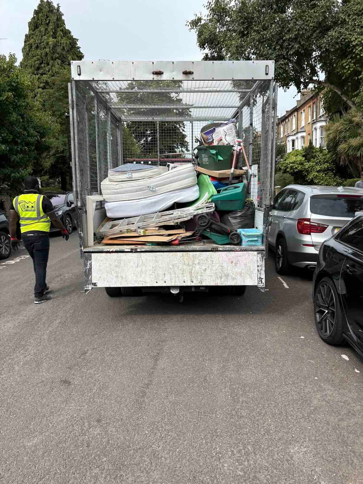 MM Rubbish Clearance team member beside loaded tipper after clearance job in North London