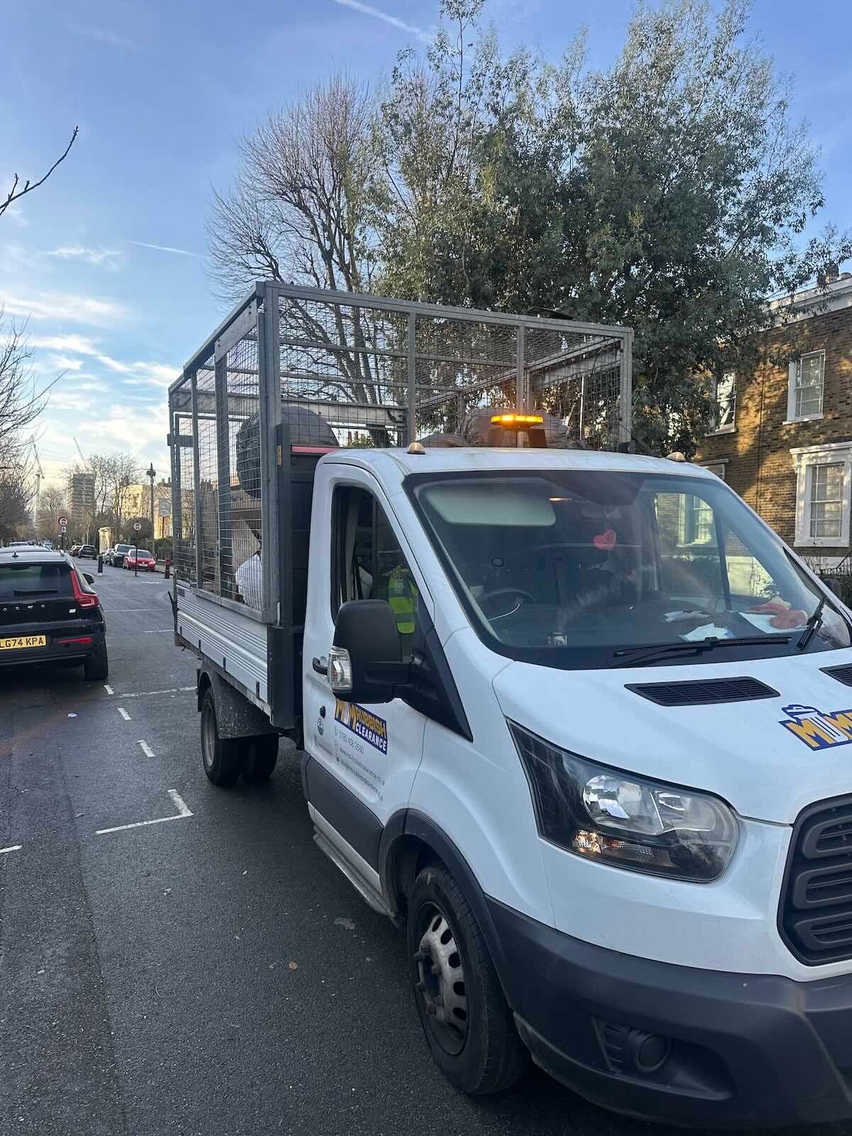 MM Rubbish Clearance van loaded with house clearance items — North London