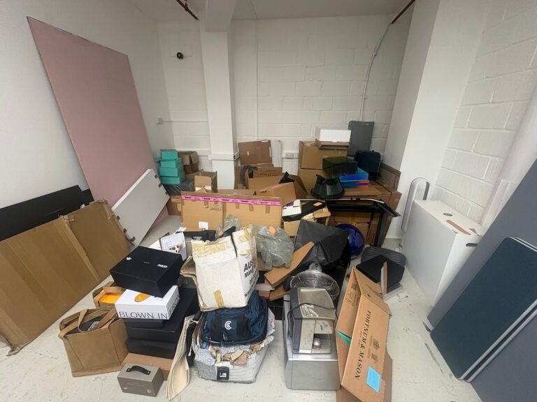 Mixed commercial waste and redundant office items in an Islington N1 storage room before clearance