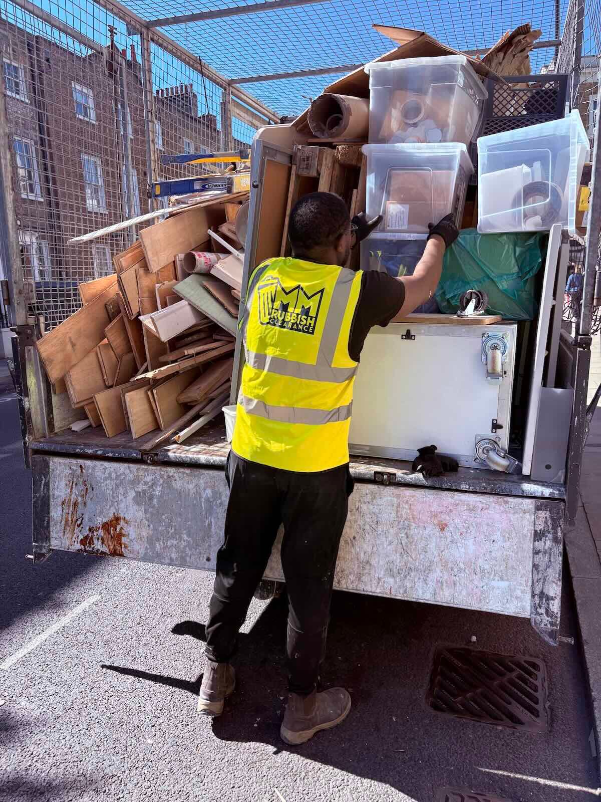 Office clearance London — commercial waste and cardboard boxes being loaded into van by MM Rubbish Clearance in N1