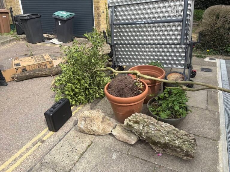 Branches, pots and garden furniture before a North London garden clearance