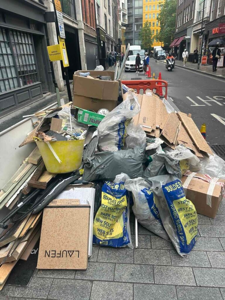 Timber, plasterboard and rubble awaiting collection on a Soho W1 project
