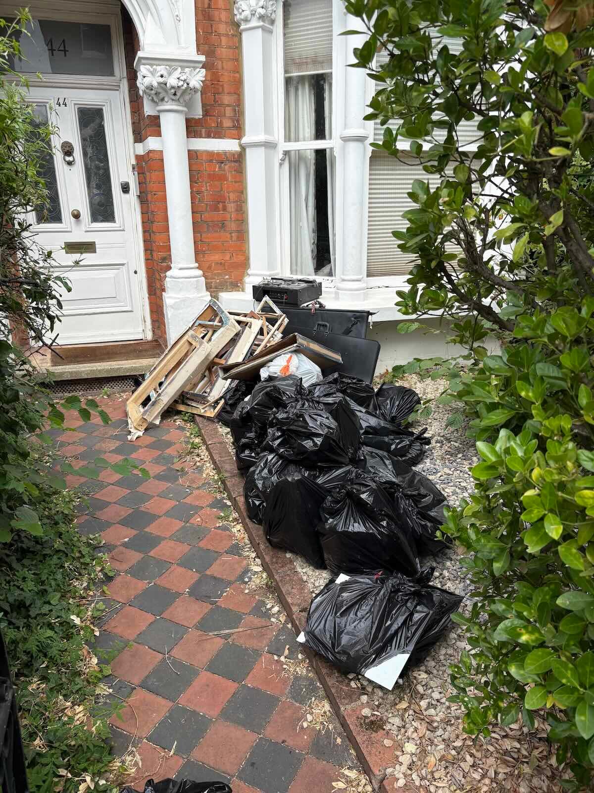 Rubbish collection Finsbury Park N4: bags of household waste outside a property on Florence Road before collection
