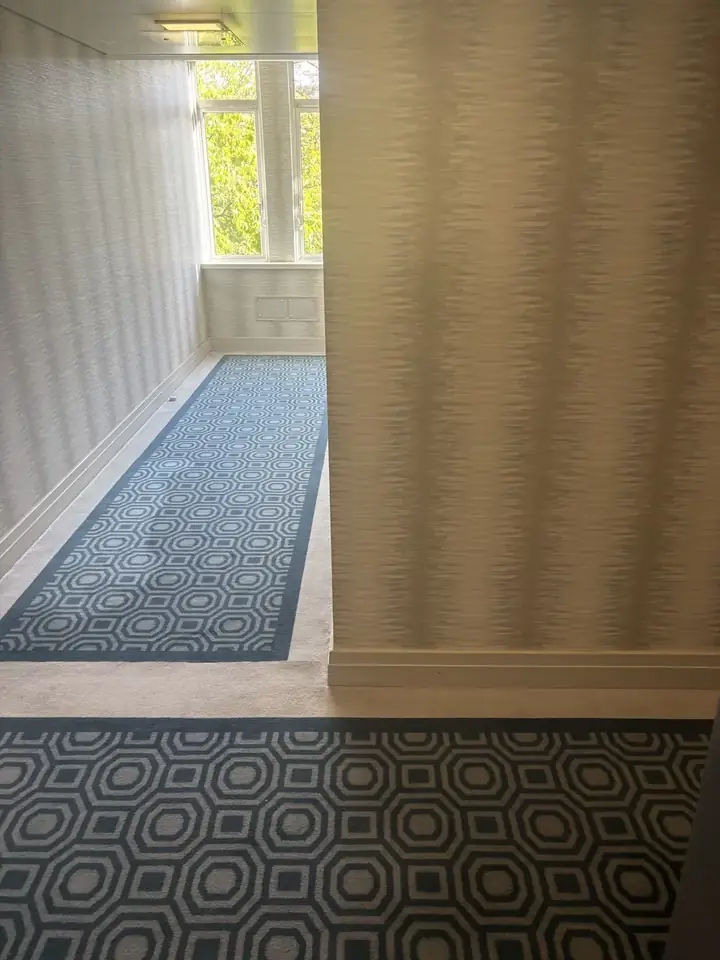 Dining table removal off Sloane Street SW1X: building corridor clear after collection, showing the right-angle turn and ceiling height the table had to clear