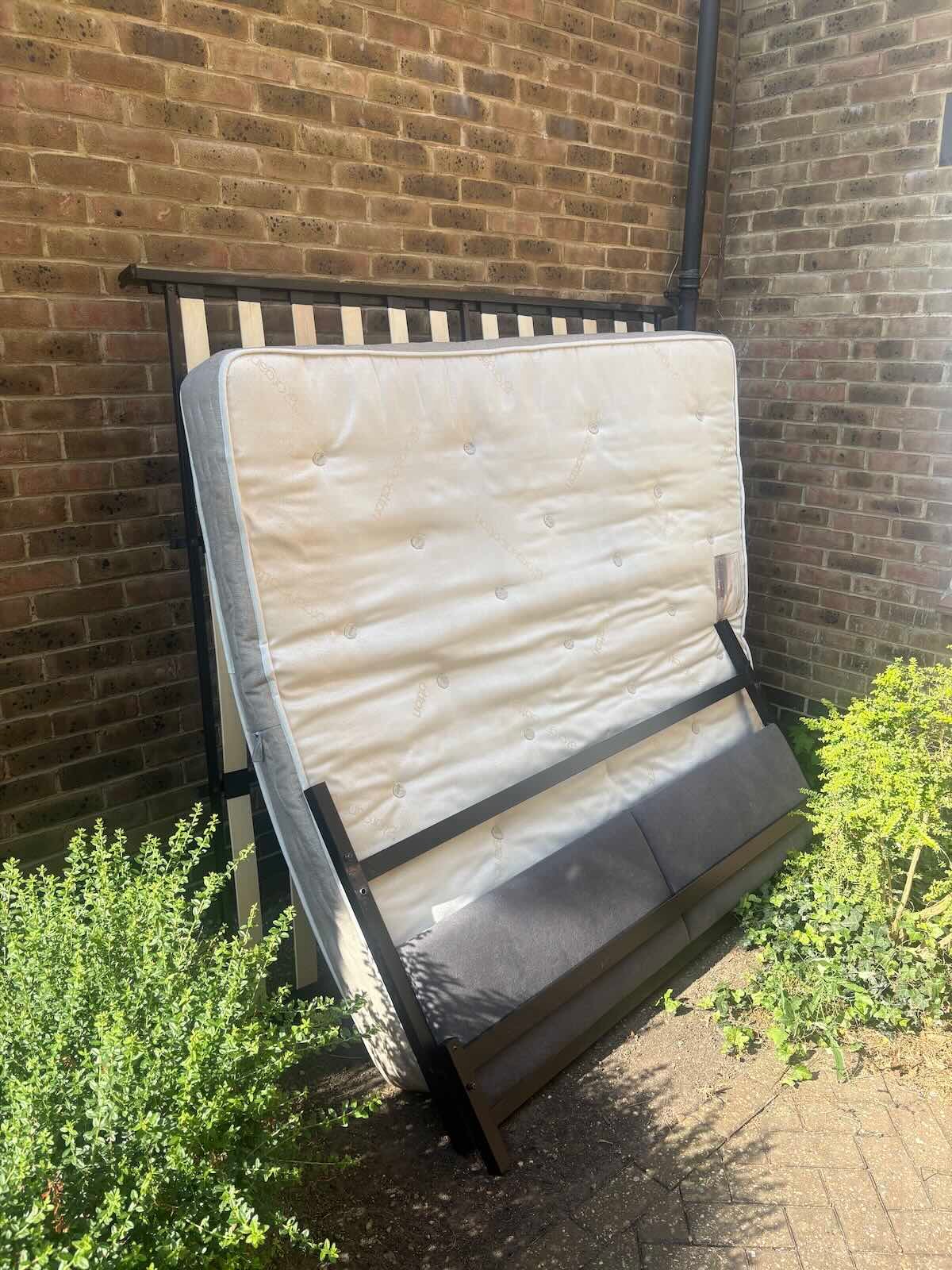 Double mattress and bed frame awaiting collection on Leighton Road, Kentish Town NW5