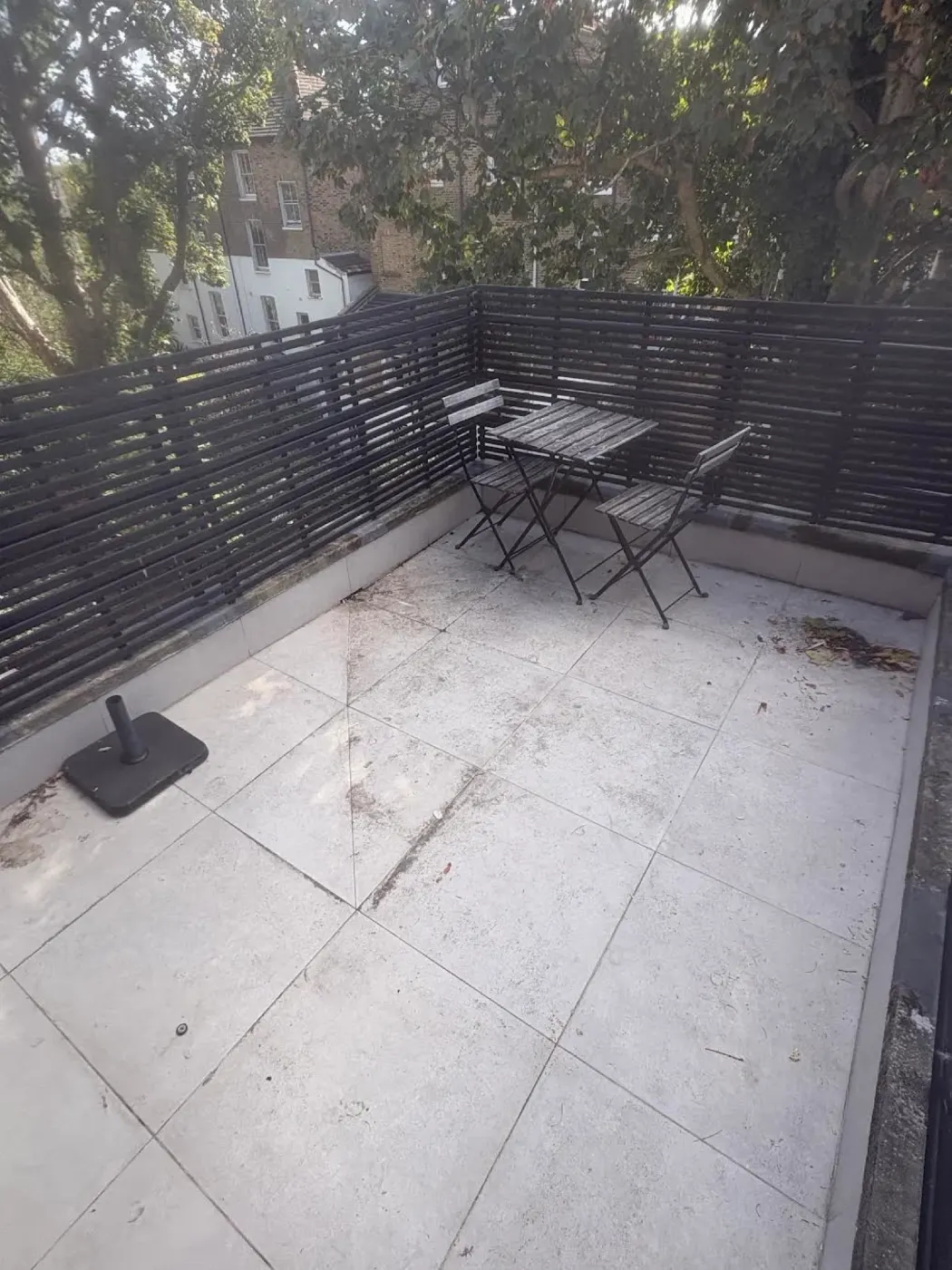 Sofa removal Canonbury N1 after collection, roof terrace clear with only the customer's bistro table, chairs and parasol base left