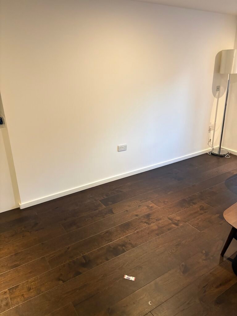 Living room cleared after corner sofa removal in N1 London