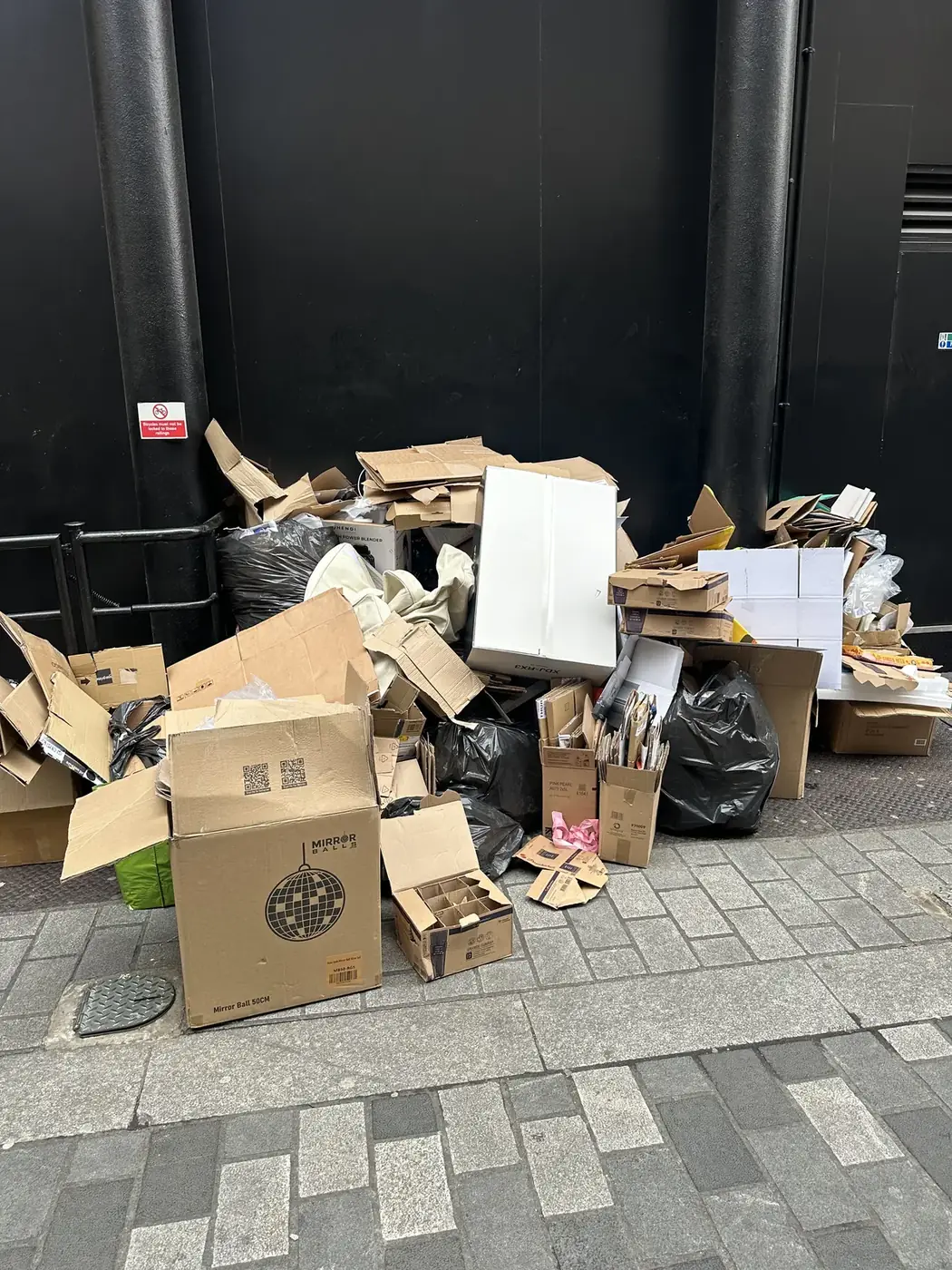Cardboard boxes, packaging and bagged rubbish before commercial waste clearance in Soho W1.